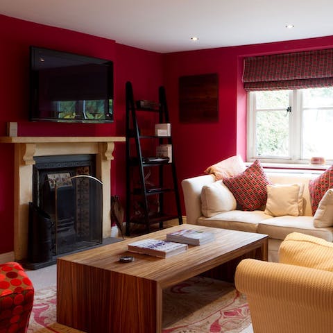 Curl up with a good book in the snug, one of three lounging spaces in this home