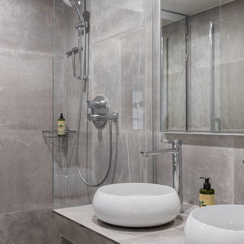 Treat yourself to a rejuvenating soak in the svelte grey bathroom