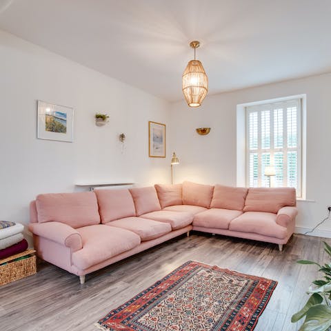 Curl up in the cosy aesthetic of the living room following sunny afternoons on the beach