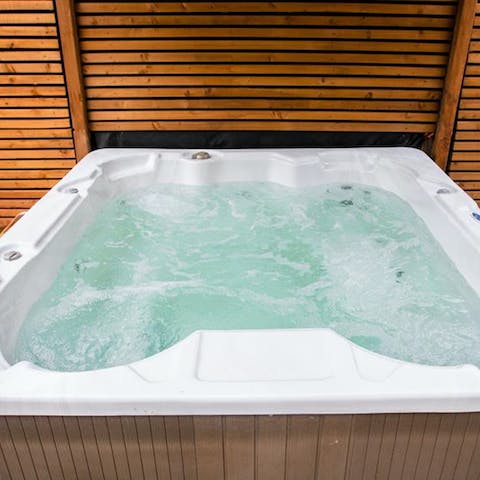 Relax and unwind in the hot tub out in the open air