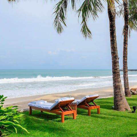 Get comfy on a sunbed and watch the waves lap the shores of Natai beach