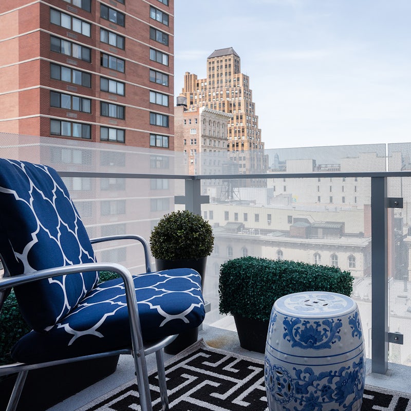 Sip a cosmopolitan cocktail on the private balcony with its views of uptown