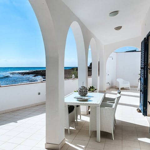 Enjoy meals with views of the sea on the covered terrace