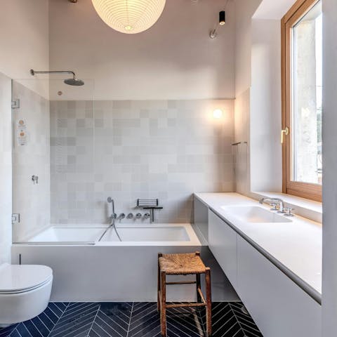 Sink into the en-suite bathtub after a day exploring the city