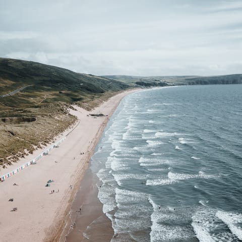 Spend the day on the sand at Woolacombe Beach, just an eighteen–minute walk away