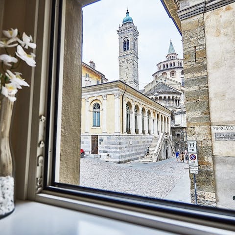 Take coffee at the bistro table with a view of Bergamo's cobbled streets
