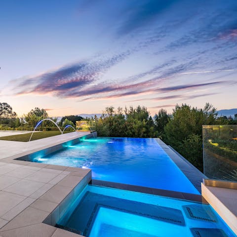 Plunge into your pristine infinity pool as the stars descend