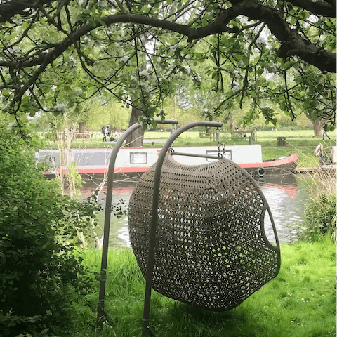 Cosy up on the garden's swing chair and watch the boats glide by