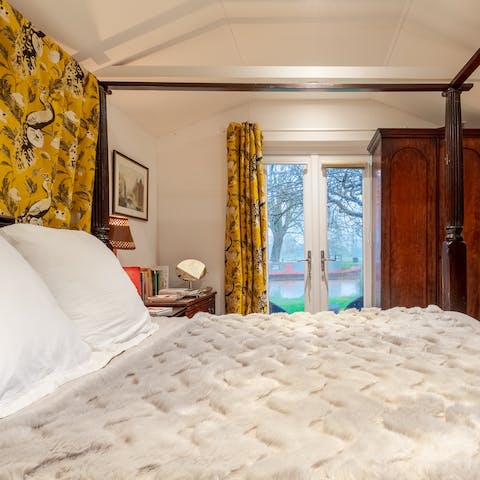 Wake up to riverside views from the four-poster bed