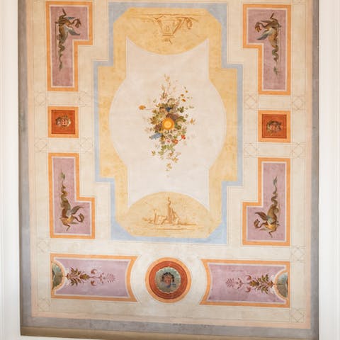 Admire the Roman frescoes on the ceilings