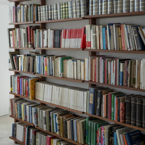 Pick a title to read from the extensive bookshelves in the study
