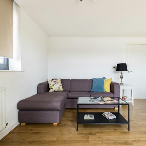 Take a moment to relax on the L-shaped sofa with a good book