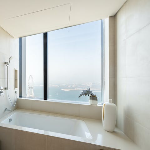 Sink into the tub and unwind with illuminated city views