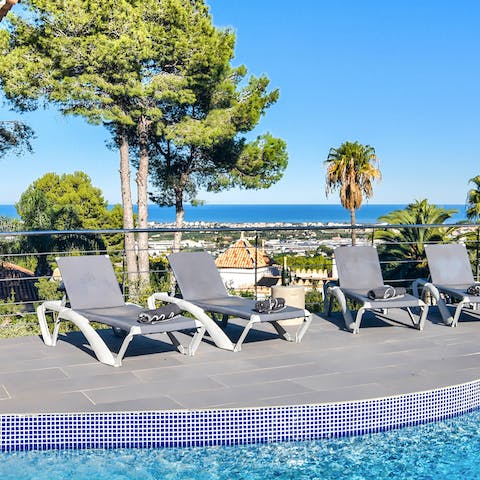 Pour yourself a drink to sip on one of the sun loungers