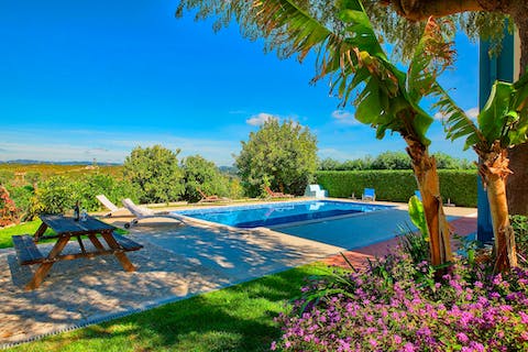 Laze on sun loungers by the pool or enjoy a glass of wine in the shade