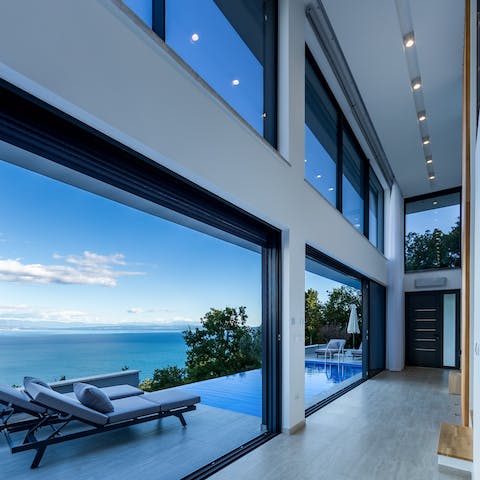 Slide open the glass walls to invite the sea breeze in