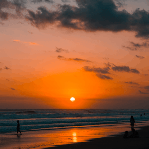 Watch the fiery sunset from Petitenget Beach or Batu Belig Beach