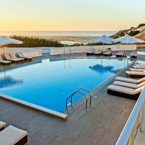 Watch the sunset by the pool just outside your door