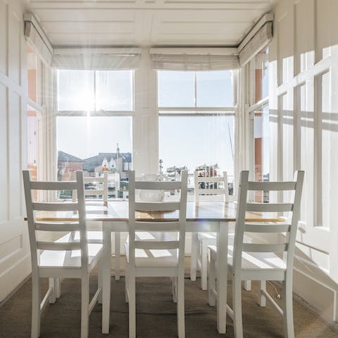 Share a meal around the dining table, admiring the beach views