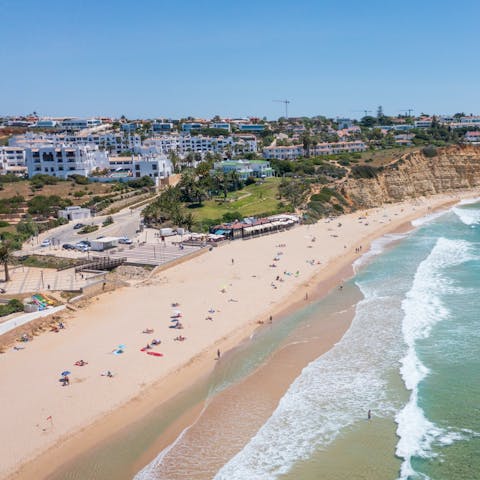 Sink your feet into the sand at Praia da Batata, 1.6km away