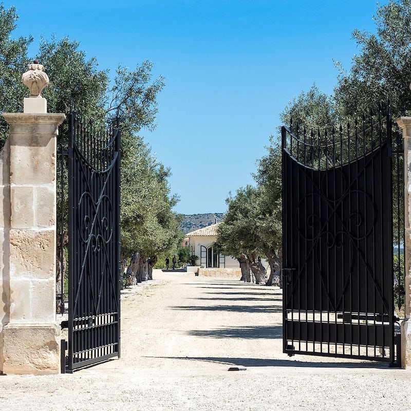 Go through the impressive gates and down the olive tree-lined drive to this gorgeous home