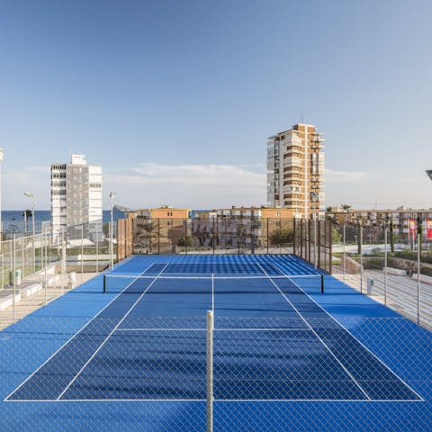 Challenge your loved ones to a game or two on the shared tennis court