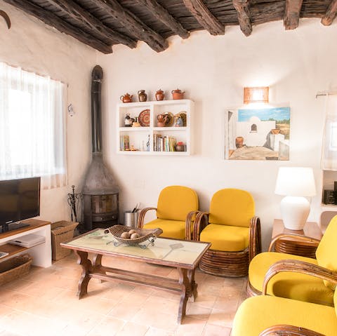 Light up the traditional fireplace and kick back on one of the yellow chairs