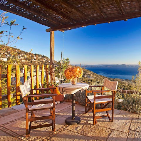 Enjoy ouzo cocktails overlooking the ocean