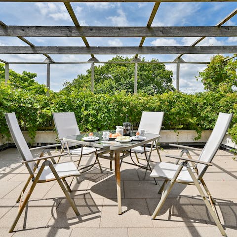 Enjoy bursts of sunny weather on the home's leafy roof terrace