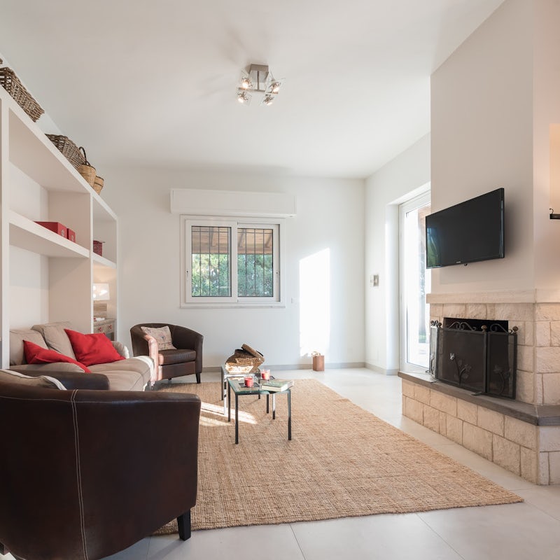 Gather on the comfy sofas in front of the fireplace and put a movie on the big screen