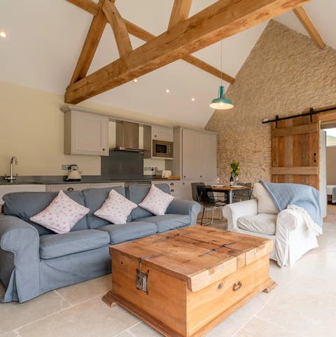 Relax underneath the original wooden beams in the roomy living area