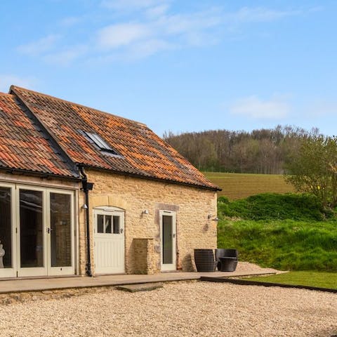 Stay in a converted barn on a working farm – the small courtyard is the perfect spot to soak up the country air