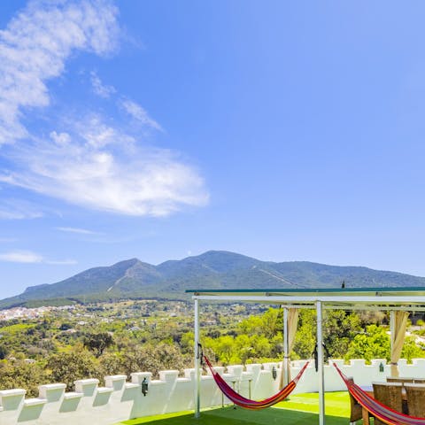 Gaze upon the breathtaking mountain views from your colourful hammock area