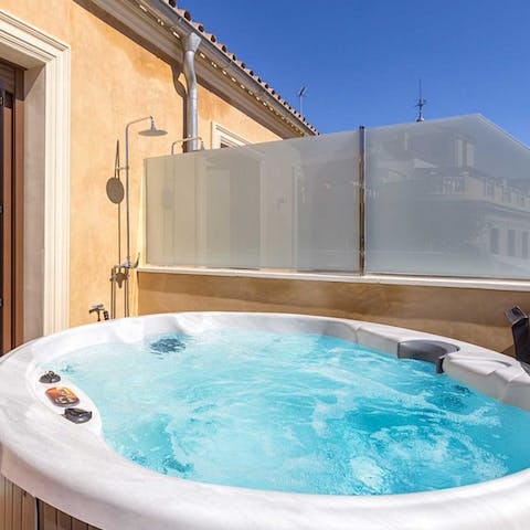 Relax in the bubbling hot tub, sipping on a nice glass of wine