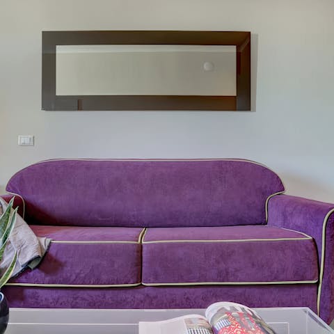 Relax on the plush purple sofa after exploring Rome