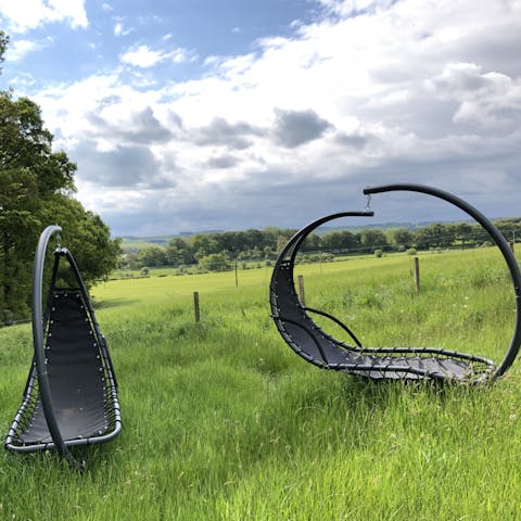 Rest with a good book while enjoying the surrounding nature from the hanging loungers