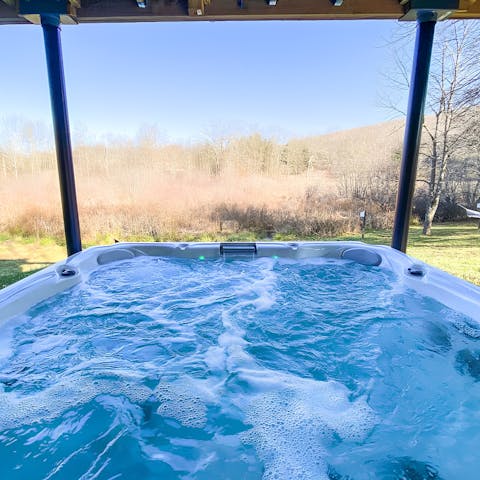 Relax in the hot tub while taking in the views of the private woodland