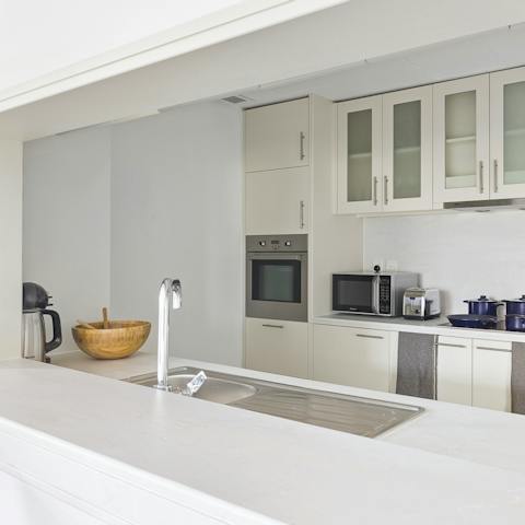 Fire up the coffee machine in the elegant kitchen to kickstart your day