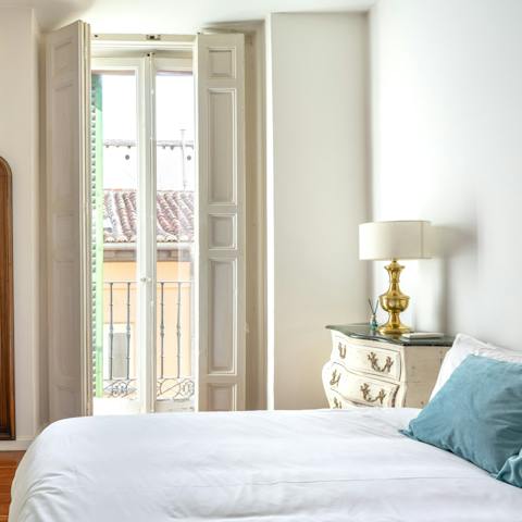 Open the French doors to the balcony and let the sunshine into your bedroom in the morning