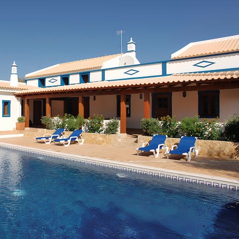 Enjoy relaxing in the sunshine by the private pool on a comfy sun lounger