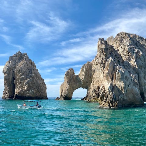 Explore the mesmerising El Arco de Cabo rock formations by boat