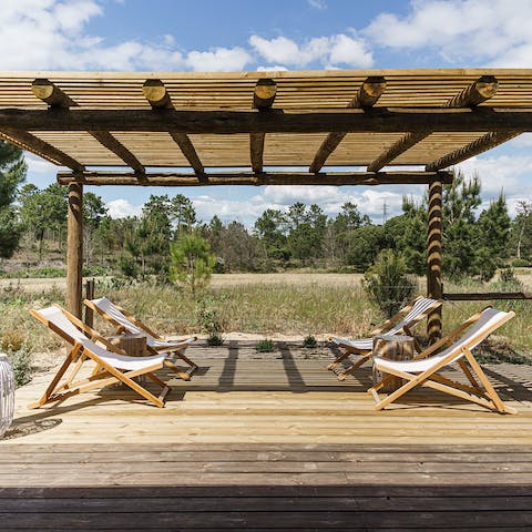 Enjoy sunset cocktails beneath the pergola, looking out at the far-stretching pine forest