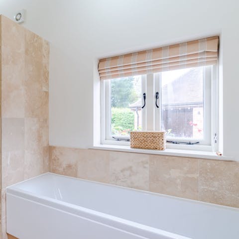 Unwind after a country walk with a soak in the main bedroom's en-suite bathtub