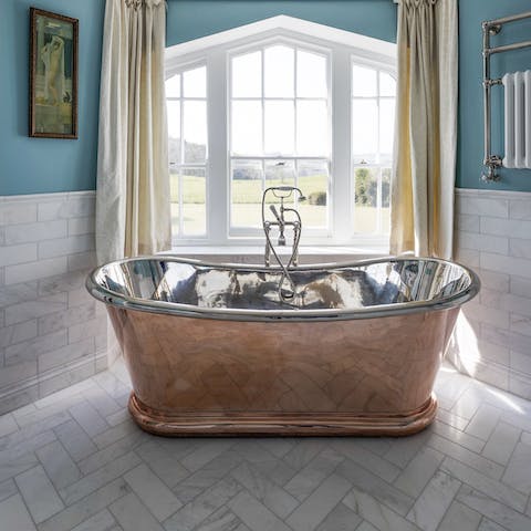 Enjoy a long soak in the striking, freestanding tub