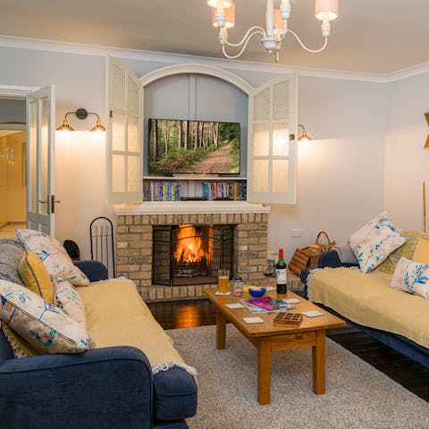 Gather everybody together around the roaring fireplace in the living room