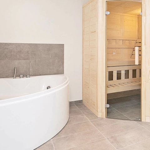 Soak in the luxurious bath or relax in the wooden sauna 
