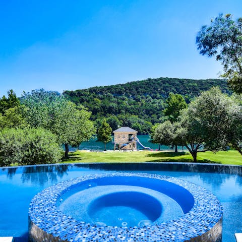 Look out over your uninterrupted lake view from the infinity pool and built-in spa