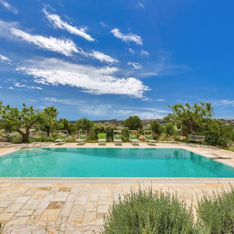 Socialise around this shared pool, boasting beautiful views over the leafy landscape
