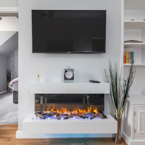 Snuggle up by the living room's electric fire on cooler evenings