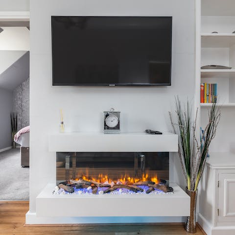 Snuggle up by the living room's electric fire on cooler evenings